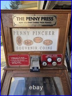 The Penny Press Penny Pincher Souvenir Coin Machine with Wooden Cabinet